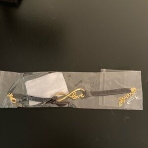 Still in plastic. Bracelet with infinity love golden design.